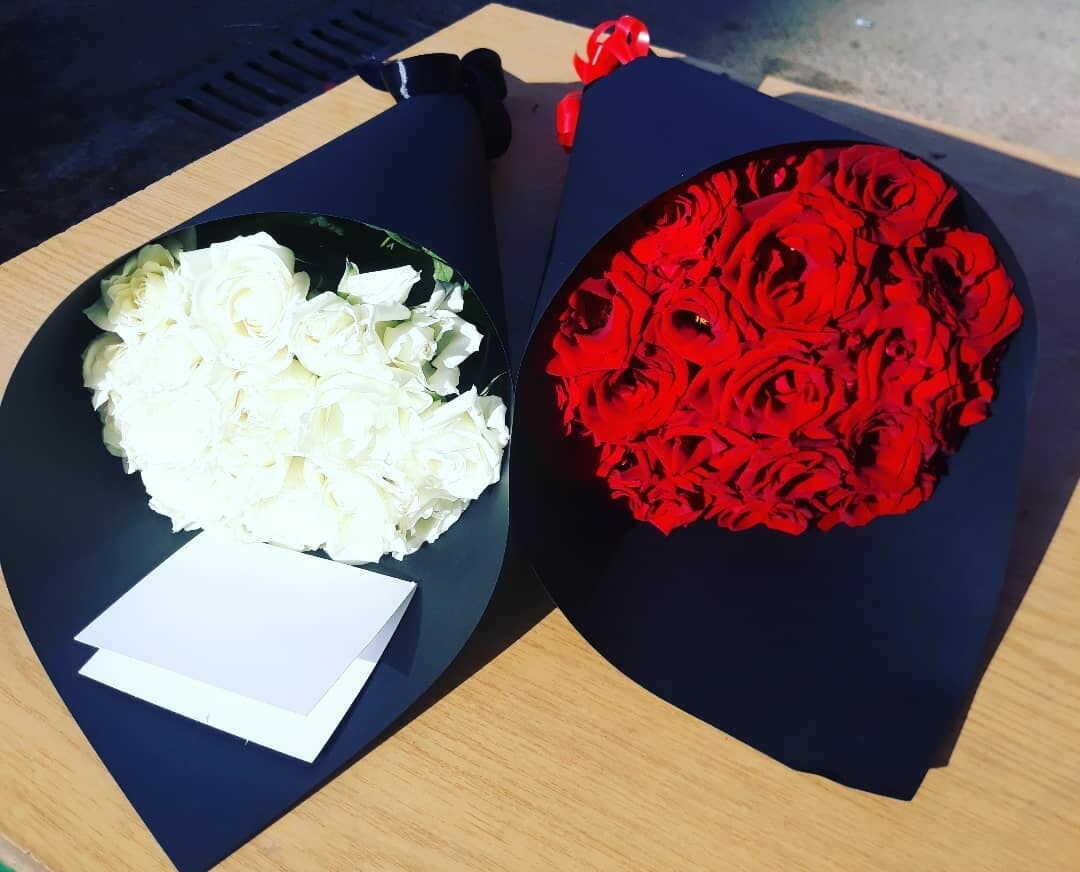 beautiful white and red flowers in a black paper