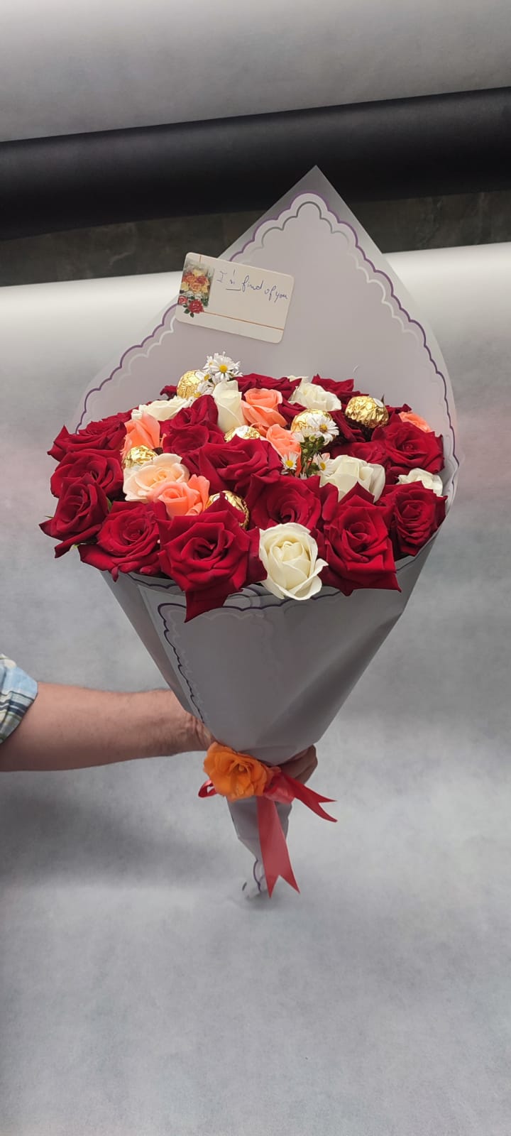 A bouquet of colorful roses with chocolates